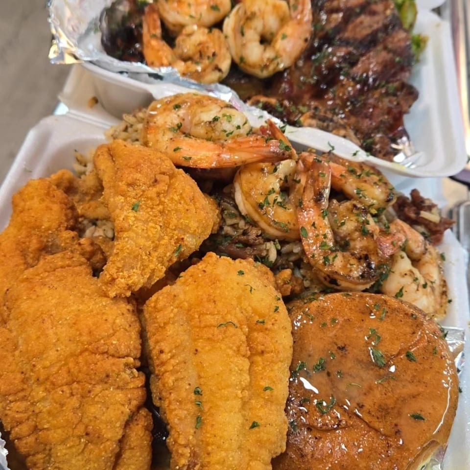 Cajun fried catfish, grilled shrimp, and rice in a takeout container from 1693 Red Zone Grill.